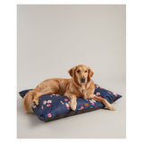 Dog lying on floral dog mattress